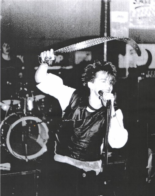 UK Decay's Abbo swirls his belt at the Manchester poly 1982.
pics Kindly donated by P.Barlow